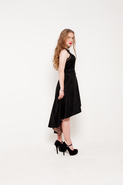 Portrait of beautiful young blonde girl in black dress. Fashion photo - Fotoğraf, Görsel