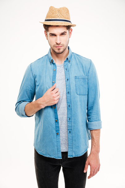 Confident attractive young man in blue shirt and hat - Foto, Imagem