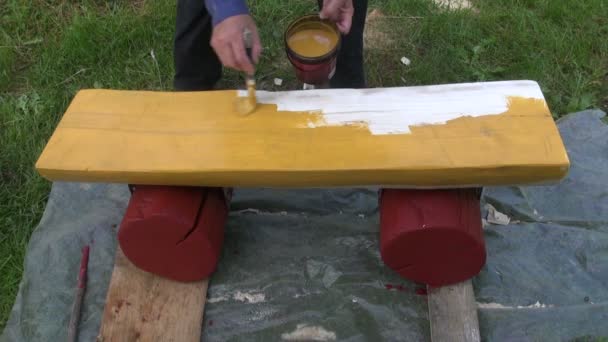 Farmer painting a bench - Footage, Video