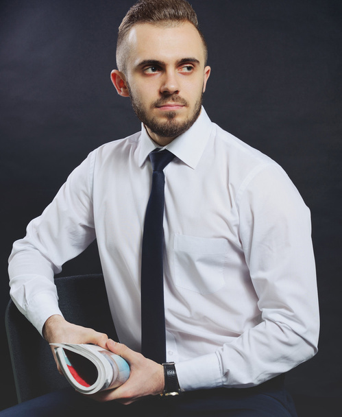 Successful businessman. Portrait of confident young man in formalwear looking at camera and smiling while keeping arms crossed and standing against grey background - Fotoğraf, Görsel
