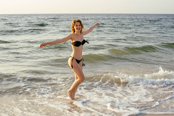 Young woman on beach  - Фото, изображение