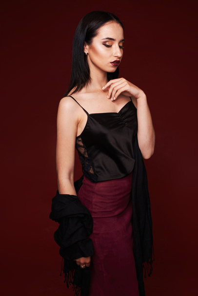 Fashion studio shot of beautiful woman with makeup and hairstyle wearing evening dress - Photo, image