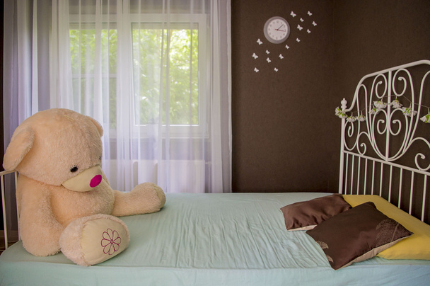 Teddy bear in a baby cot. - Photo, Image