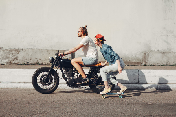young people skateboarding together on road - Foto, Imagen