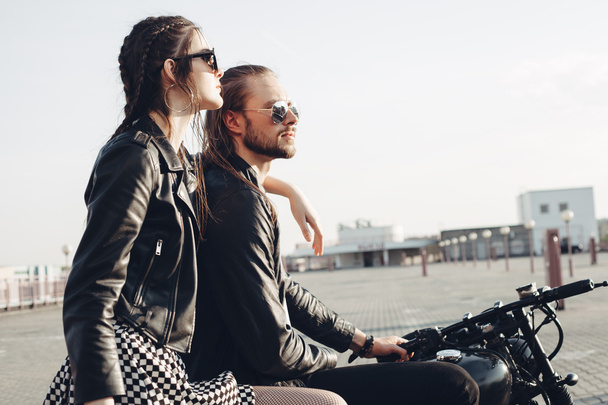 couple sitting on motorcycle at sunset - Zdjęcie, obraz