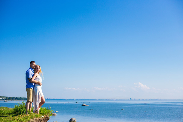 portrait of happy couple in love posing over beautiful sea view - 写真・画像