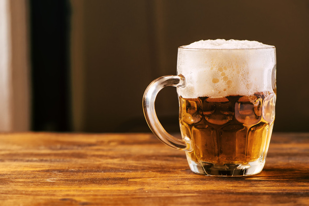 Beer mug full of cold fresh alcohol drink - Фото, зображення