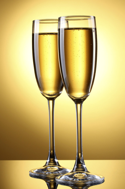 Glasses of champagne on yellow background - Photo, Image