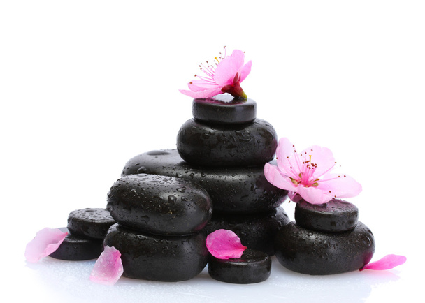 Spa stones with drops and pink sakura flowers isolated on white - Fotó, kép