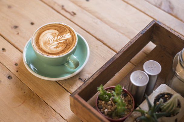 hot cappuccino with latte art on wood background - Valokuva, kuva