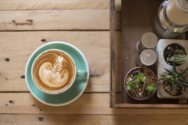 hot cappuccino with latte art on wood background - Valokuva, kuva