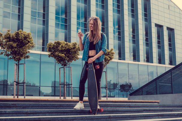 Casual blond female with longboard - Foto, afbeelding