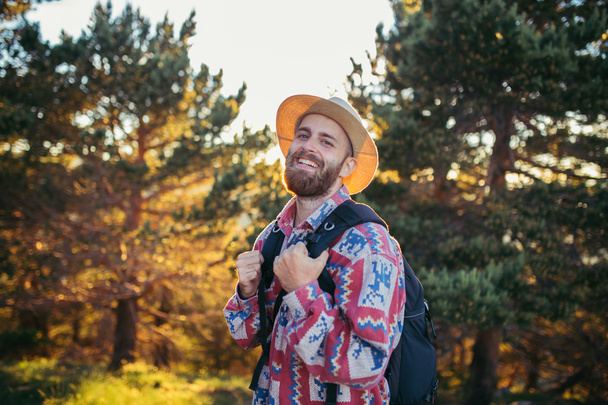 Man on hat smiling in nature  - Photo, Image