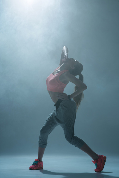 Skillful sporty girl is dancing with passion - 写真・画像