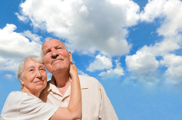 Senior couple looking in a blue sky - Photo, image