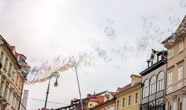 Soap bubbles on background of old town - Фото, зображення