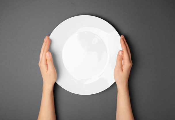 Female hands and empty plate  - Zdjęcie, obraz