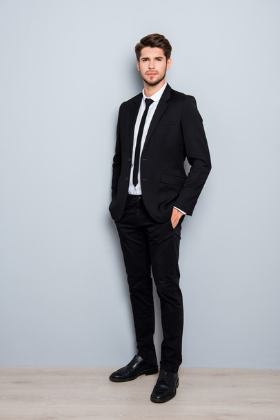 Full length portrait of handsome man in suit holding hands in po - Фото, изображение