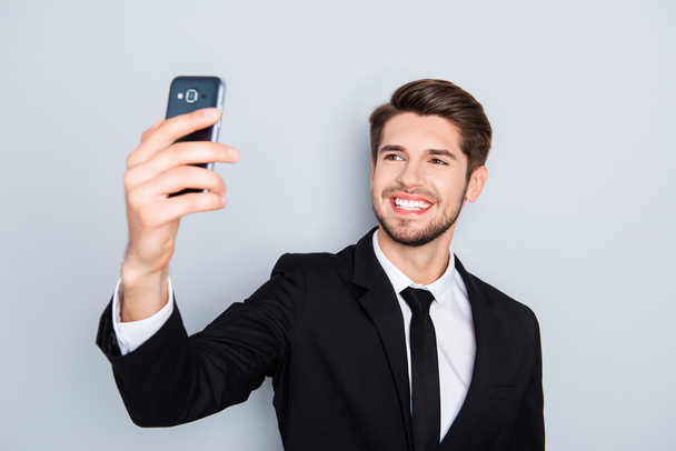 Handsome smiling man in black suit making selfie - Foto, Imagem