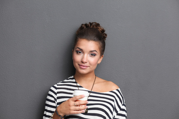 Portrait of young woman with cup tea or coffee - Fotografie, Obrázek