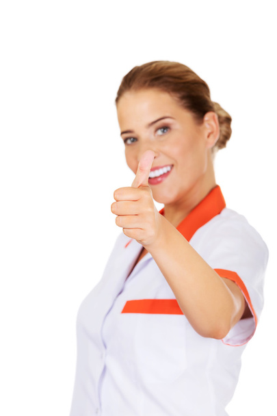 Young smile female doctor or nurse with thumbs up - Foto, Imagem