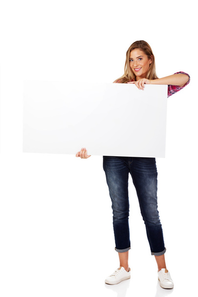 Young smiling woman holding empty banner - Photo, image