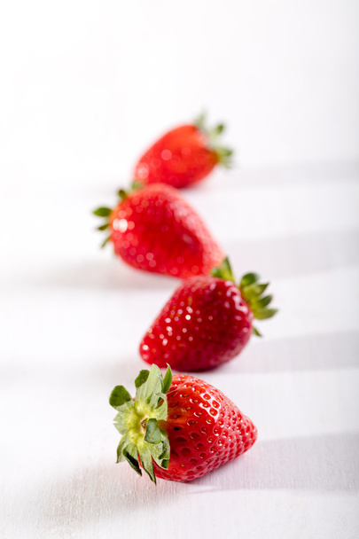Four juicy strawberry on the table - Фото, зображення