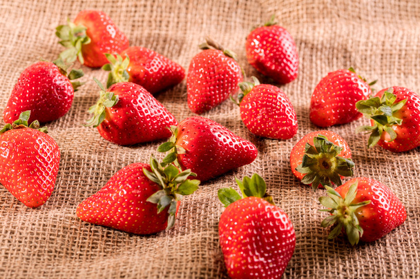 Fresh juicy strawberry on jute bag - Photo, image