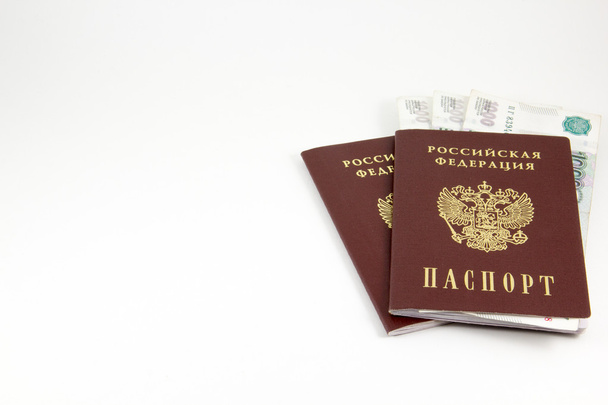 Паспорта Российской Федерации и деньги на белом фоне
 - Фото, изображение