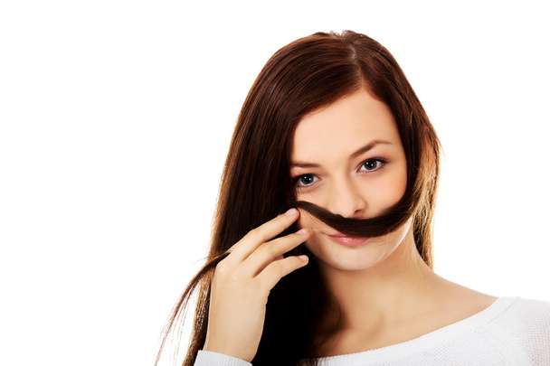 Funny student woman putting hair like moustache - Photo, image