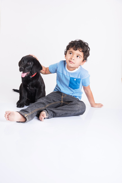 indian child with dog or puppy - 写真・画像