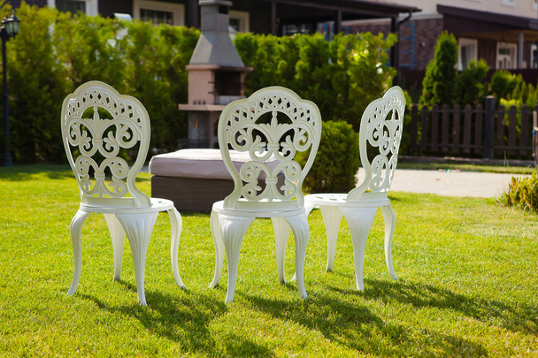 carved white chairs on the lawn in the courtyard - Photo, Image