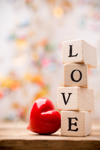 Heart. Written on wooden blocks love and red heart. - Фото, зображення