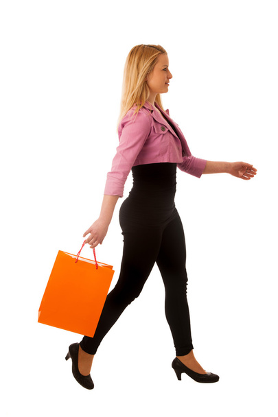 Cute blonde woman with shopping vibrant bags isolated over white - Foto, Imagem