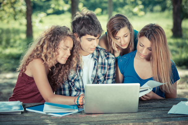 Group of Teenage Students at Park with Computer and Books - Valokuva, kuva