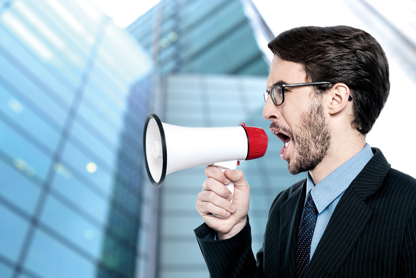 Businessman using a megaphone to announce - Photo, image