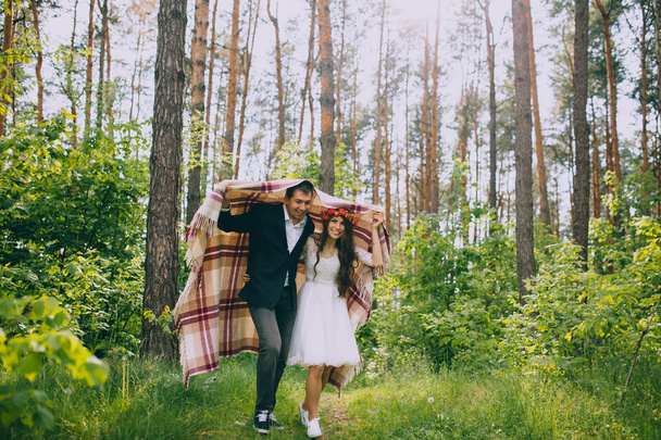 Newlyweds having fun in forest - Photo, image