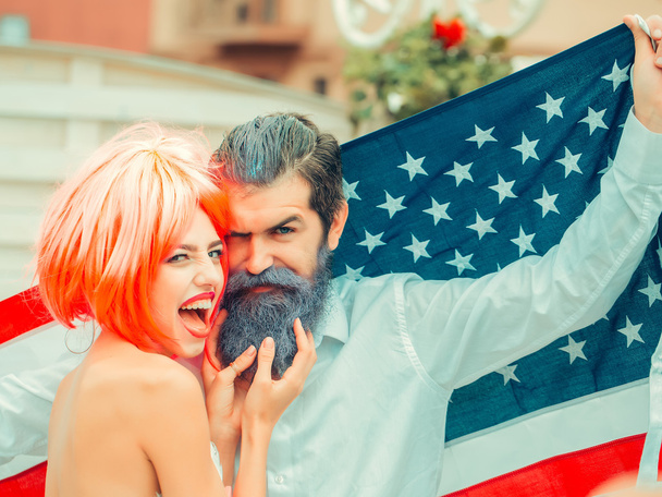 Happy young patriotic American couple bright make up and hair celebrating Independence Day on 4th of July - Photo, Image