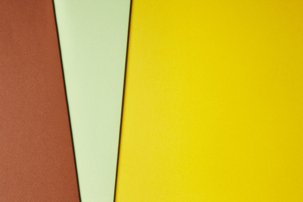 Colored cardboards background in yellow green brown tone. Copy s - Zdjęcie, obraz