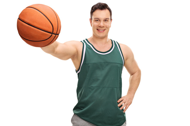 Young guy holding a basketball  - Фото, зображення