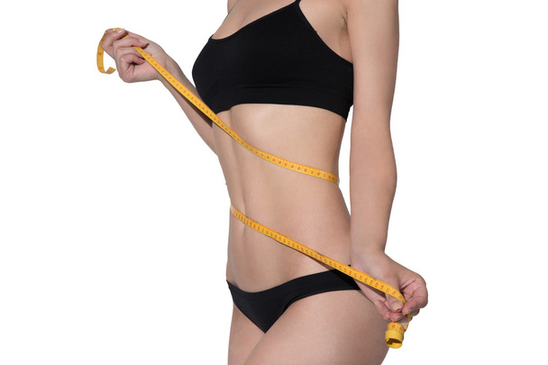Slim woman body in black underwear measurement on white backgrou - Foto, Imagen