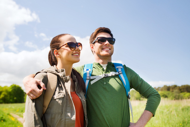 happy couple with backpacks hiking outdoors - Foto, Imagen