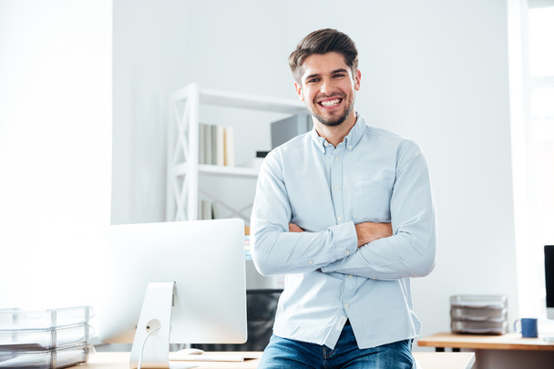 Happy confident young businessman standing in office - Fotografie, Obrázek