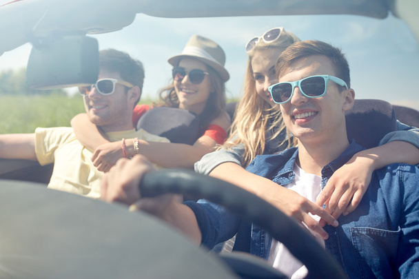 happy friends driving in cabriolet car  - Photo, Image