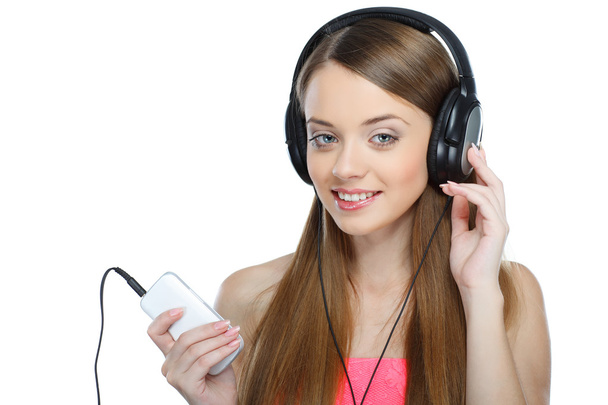 Beautiful girl with headphones listening music isolated on a white background - Foto, immagini