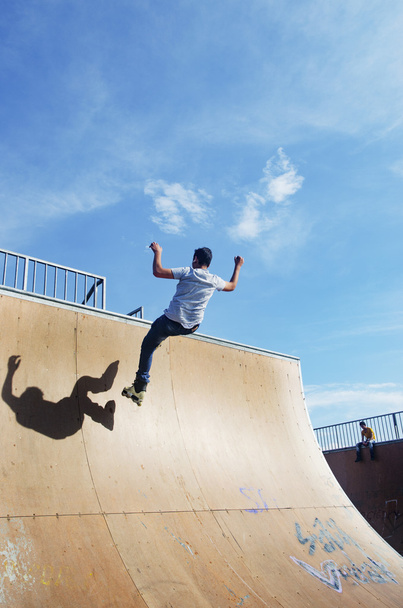 Young skaters under the blue sky seems almost like flying - Foto, Imagen