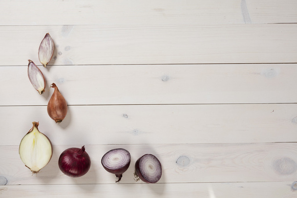 flat lay of onions on white wood - Foto, afbeelding