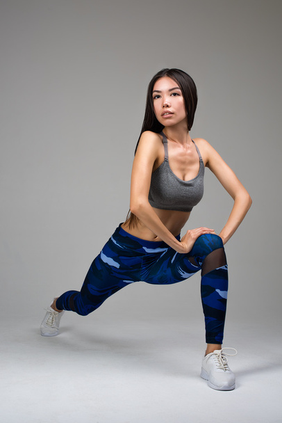 Hermosa mujer en forma haciendo ejercicio de estiramiento
 - Foto, imagen