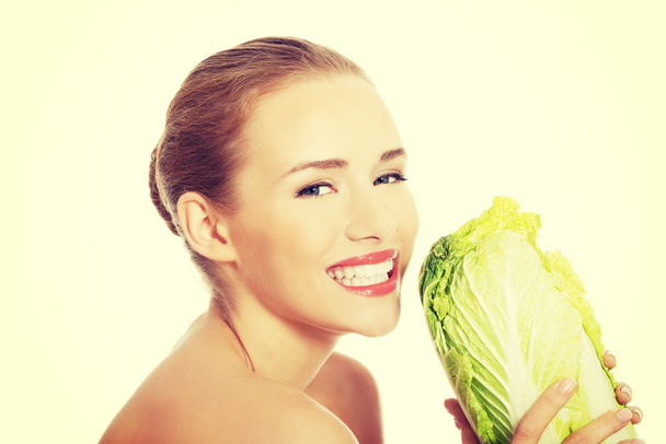 Beautiful woman with iceberg lettuce. - Фото, зображення