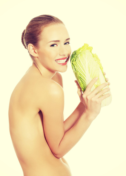 Beautiful woman with iceberg lettuce. - Zdjęcie, obraz